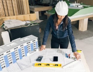 african american lady safety helmet standing near model building